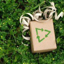 Photo: Gift wrapped in brown paper with a recycle symbol 