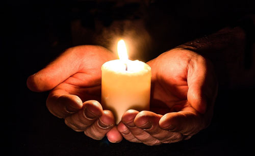 Photo: Person holding a candle