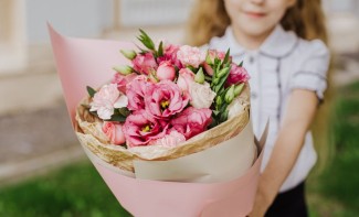 Photo: Child giving parent a flower