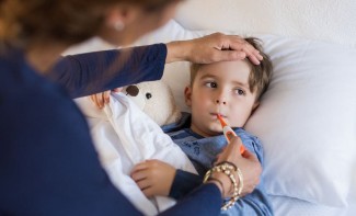 Photo: Boy having his temperature taken