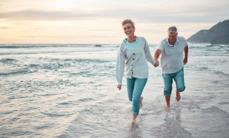 Photo: Older Couple Walking on the Beach