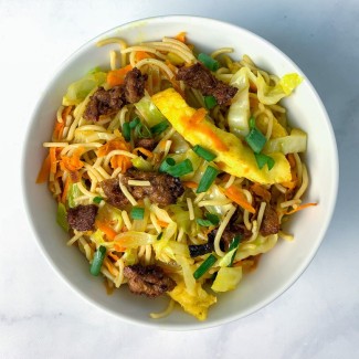 Bowl of fried noodles, vegetables and vegan char siu meat