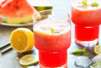 Photo: Watermelon Lemonade with watermelon slices in the background