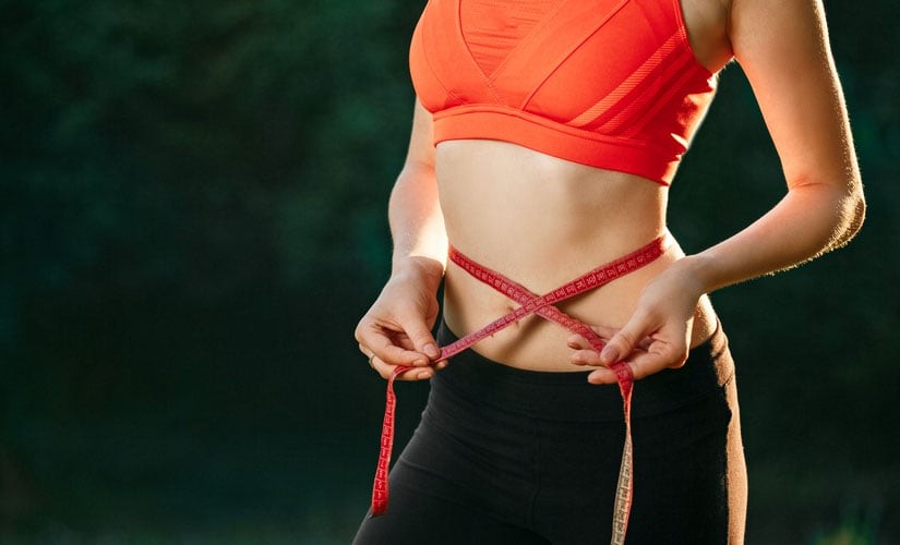 Photo: Woman measuring her stomach