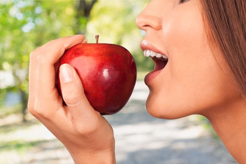 Photo: Woman biting an apple