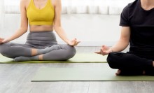 Photo: Young couple meditating together