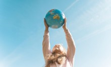 Photo: Girl holding a globe