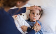 Photo: Mother taking her son's temperature