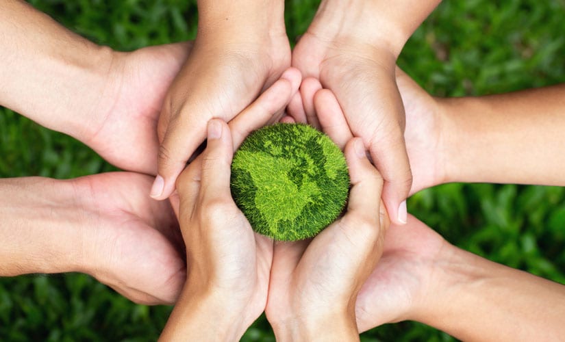 Photo: Hands holding the planet